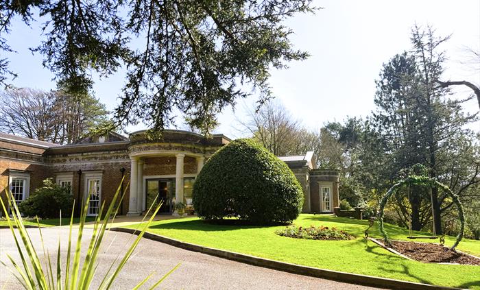 Country hotel entrance with a drive and greenery